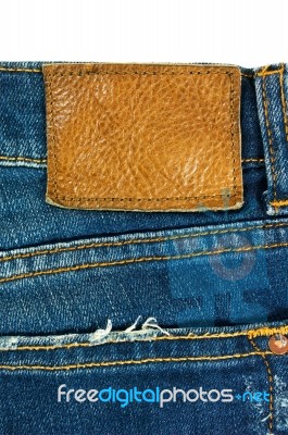 Blue Jeans With Leather Label On White Stock Photo