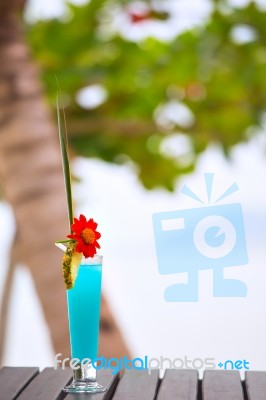 Blue Lagoon Cocktail On The Table At Tropical Beach Stock Photo