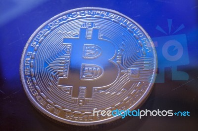 Blue Light On Bitcoin Currency Coin Extreme Close-up Stock Photo