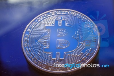 Blue Light On Bitcoin Currency Coin Extreme Close-up Stock Photo