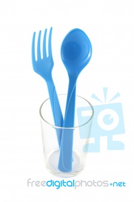 Blue Plastic Utensil In Glass Stock Photo