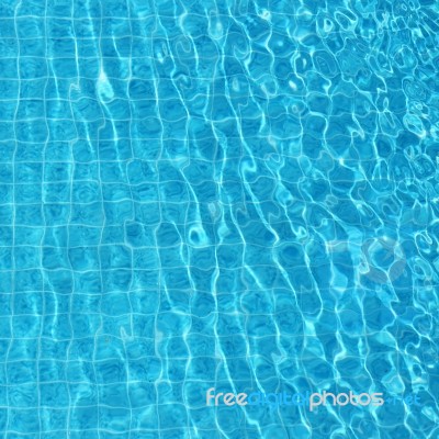 Blue Rippled Water Background In Swimming Pool Stock Photo