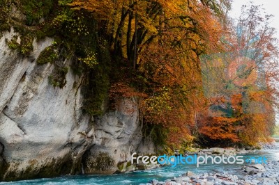 Blue River With Autumn Colors On The Trees Stock Photo