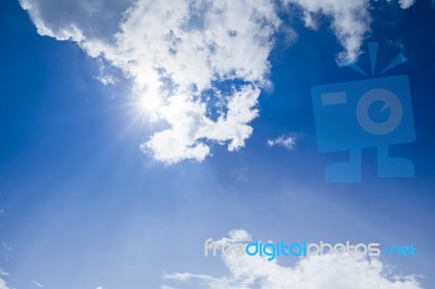 Blue Sky With Clouds And Sunlight Stock Photo