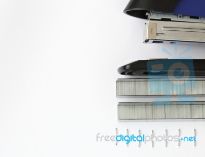 Blue Stapler And Staples With Paper On The Table Stock Photo