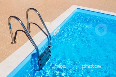 Blue Swimming Pool With Ladder Stock Photo