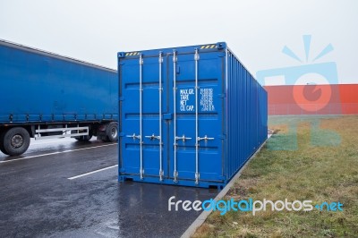 Blue Transportation Container And Truck On Parking Stock Photo