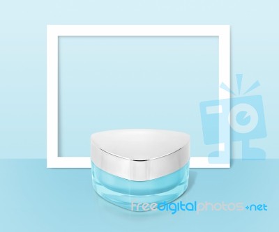 Blue Triangle Cosmetic Jar On Paper Frame Background Stock Photo