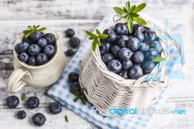 Blueberry Basket And Jug On White Wooden Table Stock Photo