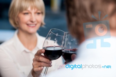 Blur Images Of Couple Raises A Glass Of Red Wine Stock Photo