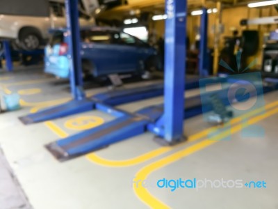 Blurred Background Of Technician Repairing The Car In Garage Stock Photo