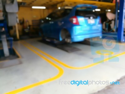 Blurred Background Of Technician Repairing The Car In Garage Stock Photo