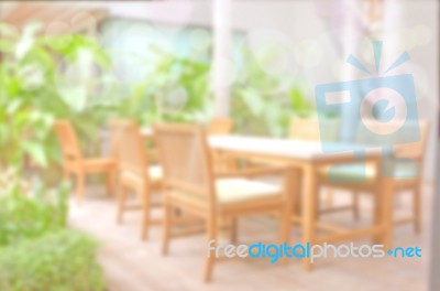 Blurred Backyard Garden Background With Dining Wood Table Set Stock Photo