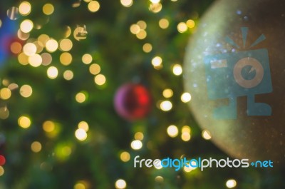 Blurred Glitter Ball Celebrate Christmas Tree With Illumination Bulb Light Background, Soft Color Cinematic Vignette Tone Stock Photo