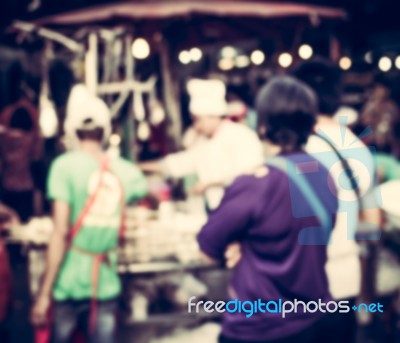 Blurred People Buying Food On The Street At Night Stock Photo