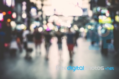 Blurred People On The Street At Night Stock Photo