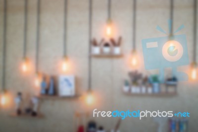 Blurred Vintage Hanging Light Bulb On The Wall Stock Photo