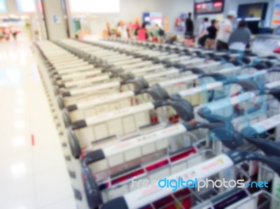 Blurry Of Luggage Trolley  And Passenger In The Airport Hall Stock Photo