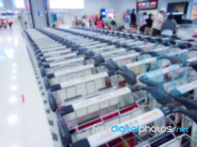 Blurry Of Luggage Trolley  And Passenger In The Airport Hall Stock Photo