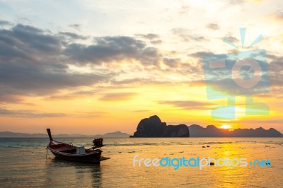 Boat On Beach And Sunrise Stock Photo