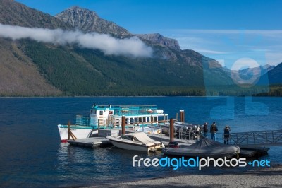 Boats Moored To A Jetty In Lake Mcdonald Stock Photo