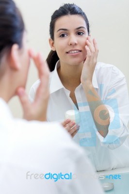 Body Care. Woman Applying Cream On Face Stock Photo