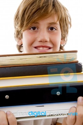 Book Pile With Student Holding Books Stock Photo