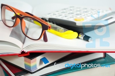 Book Stack With Glasses And Calculator Stock Photo