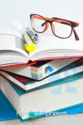 Book Stack With Reading Glasses Stock Photo