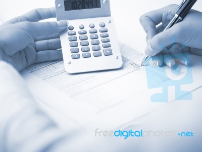 Bookkeeping With Calculator Stock Photo