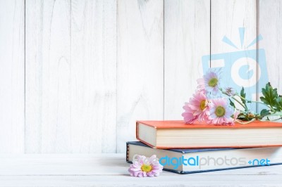 Books Or Journal With Flowers Arranged On A Neutral White Painted Desk Stock Photo