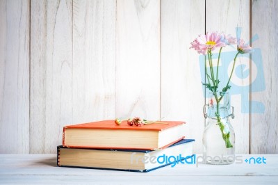 Books Or Journal With Flowers Arranged On A Neutral White Painted Desk Stock Photo