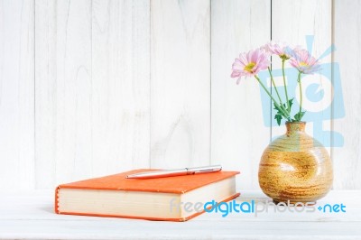 Books Or Journal With Flowers Arranged On A Neutral White Painted Desk Stock Photo