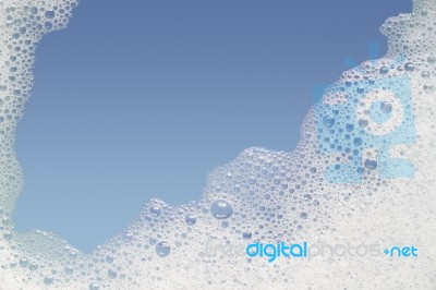 Border Of Bubble Foam Soap In Blue Water Stock Photo