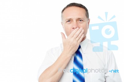 Bored Senior Executive Yawning Stock Photo