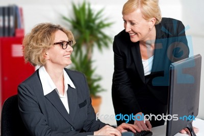 Boss Taking Help Of Her Secretary In Office Work Stock Photo