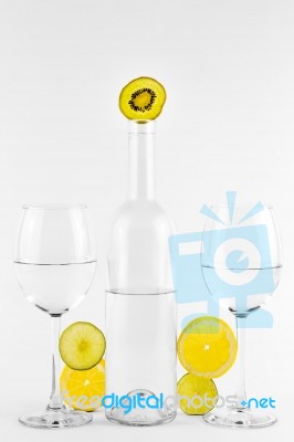 Bottle And Glasses With Water, Lemon, Kiwi And Lime Stock Photo