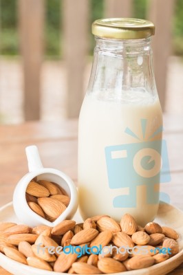 Bottle Of Almond Milk On Wooden Table Stock Photo