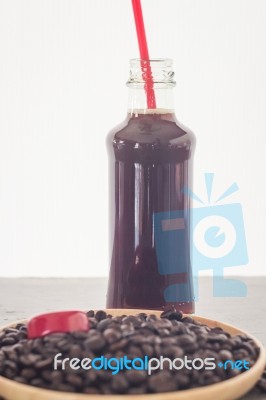 Bottle Of Black Coffee With Roast Bean Stock Photo