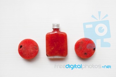 Bottle Of Fresh Watermelon Juice With  Watermelon Pieces  On Whi… Stock Photo