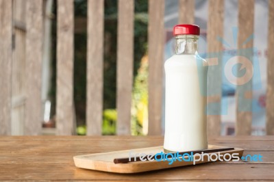 Bottle Of Milk On Wooden Table Stock Photo