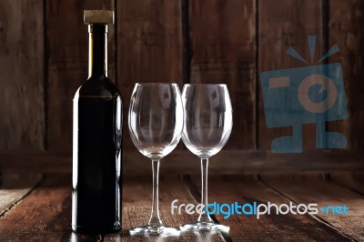 Bottle Of Red Wine And Two Empty Glasses Stock Photo