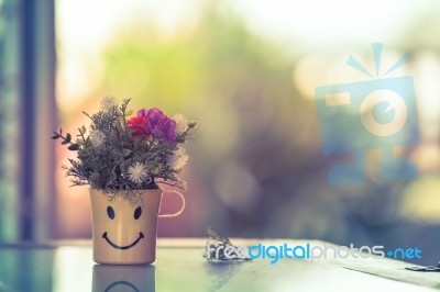 Bouquet Of Artificial Flowers On Happy Cup. Vintage Picture Style Stock Photo