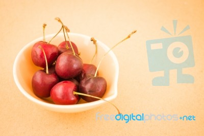 Bowl Of Cherries On Warm Vintage Background Stock Photo