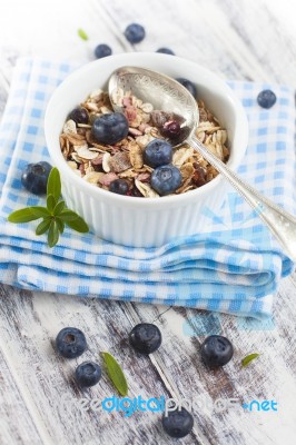 Bowl Of Muesli With Fresh Blueberries On White Wooden Table Stock Photo