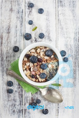 Bowl Of Muesli With Fresh Blueberries On White Wooden Table Stock Photo