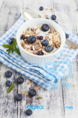 Bowl Of Muesli With Fresh Blueberries On White Wooden Table Stock Photo