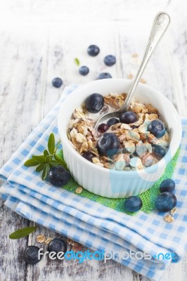 Bowl Of Muesli With Fresh Blueberries On White Wooden Table Stock Photo