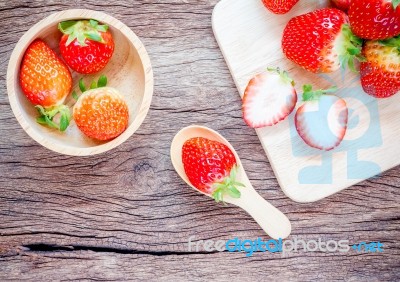 Bowl With Fresh Strawberries On An Old Wooden Table Stock Photo