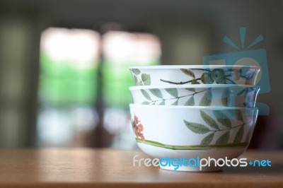 Bowls On A Wooden Desk And Living Room Background Stock Photo